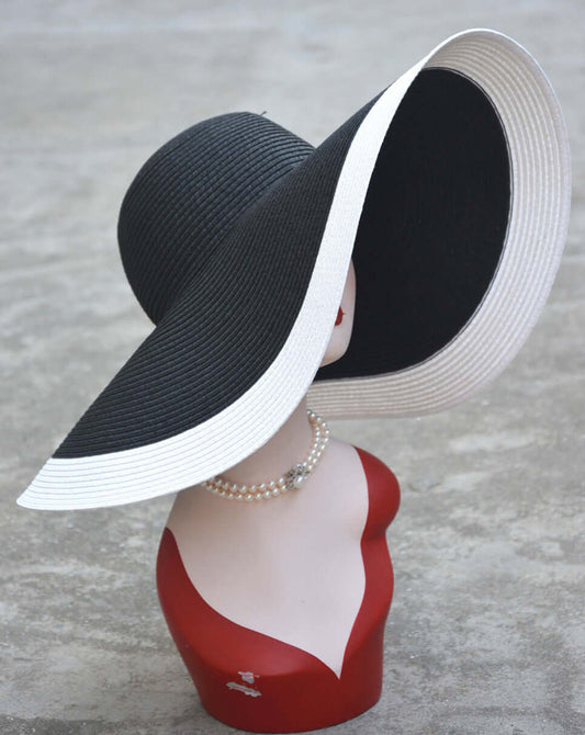 Big Straw Hat showcased on a mannequin, featuring a wide-brim black design with white accents, perfect for sunny days.