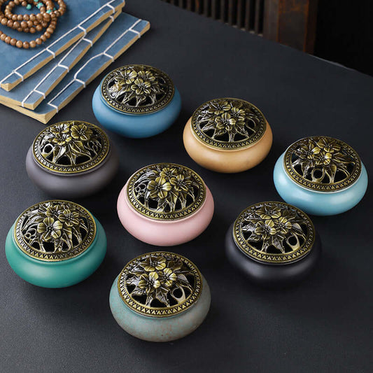 Set of eight colorful ceramic incense burners with intricate floral copper lids, perfect for adding ambiance.