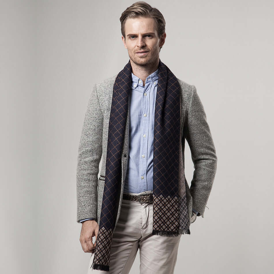Man wearing a Classic Plaid Warm Scarf, styled with a light gray blazer, showcasing a fashionable winter accessory for cold weather.