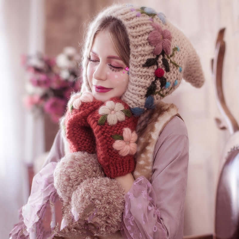 Model wearing a cozy Knitted Wool Hat with floral designs and matching mittens, exuding warmth and style.