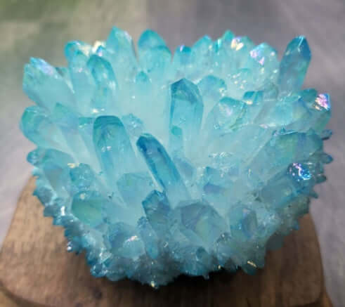 Crystal Therapy Healing Stone with shimmering blue crystals on a wooden base, promoting wellness and serenity.