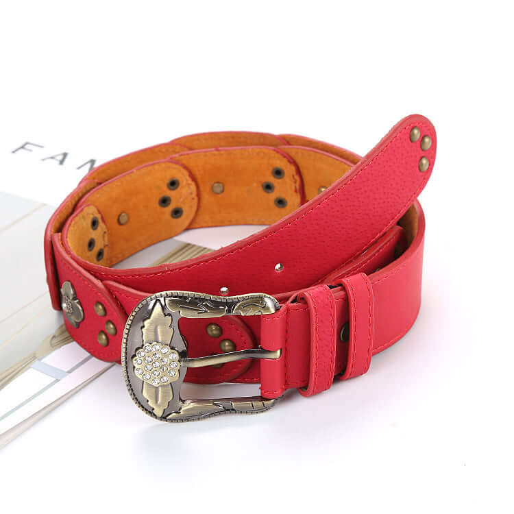 Red leather floral belt with intricate buckle design, showcasing elegance and style in fashion accessories.