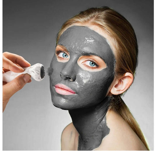 Woman applying Facial Mud Mask for deep cleansing and softening skin, enriched with natural ingredients to remove dead skin cells.