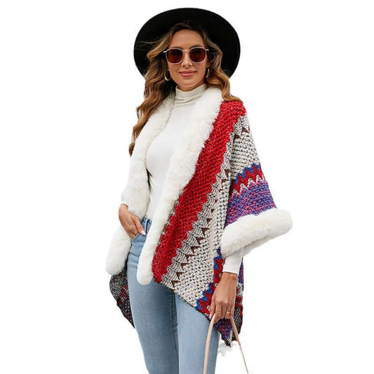 Stylish woman wearing a colorful fur trimmed poncho with sunglasses and a hat, perfect for autumn and winter fashion.