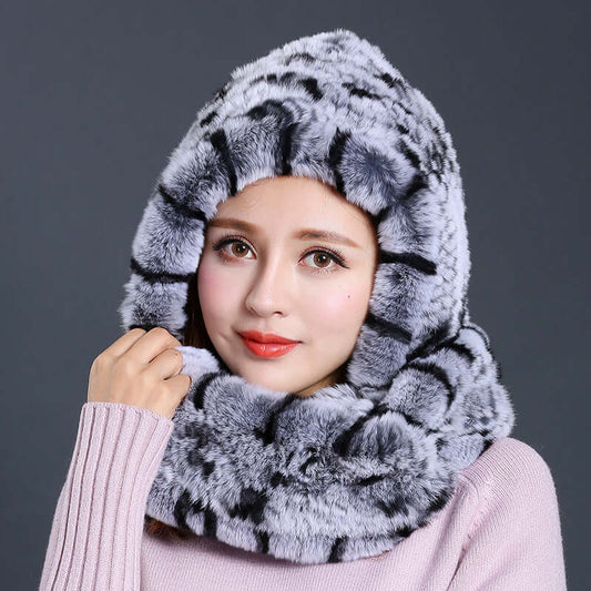 Stylish woman wearing a luxurious faux fur hat with scarf combination in a chic gray design, perfect for winter layering.