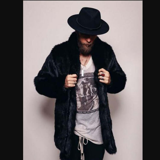 Man wearing a stylish mink-like faux fur coat and black hat, showcasing fashionable winter attire.