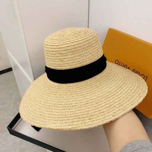 Raffia big brim hat with black accent, perfect for summer style and sun protection.