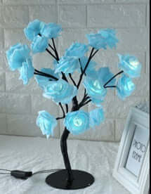 Illuminate your home with the elegant Rose Small Tree Lamp, featuring blue rose-shaped lights on a stylish black stand.