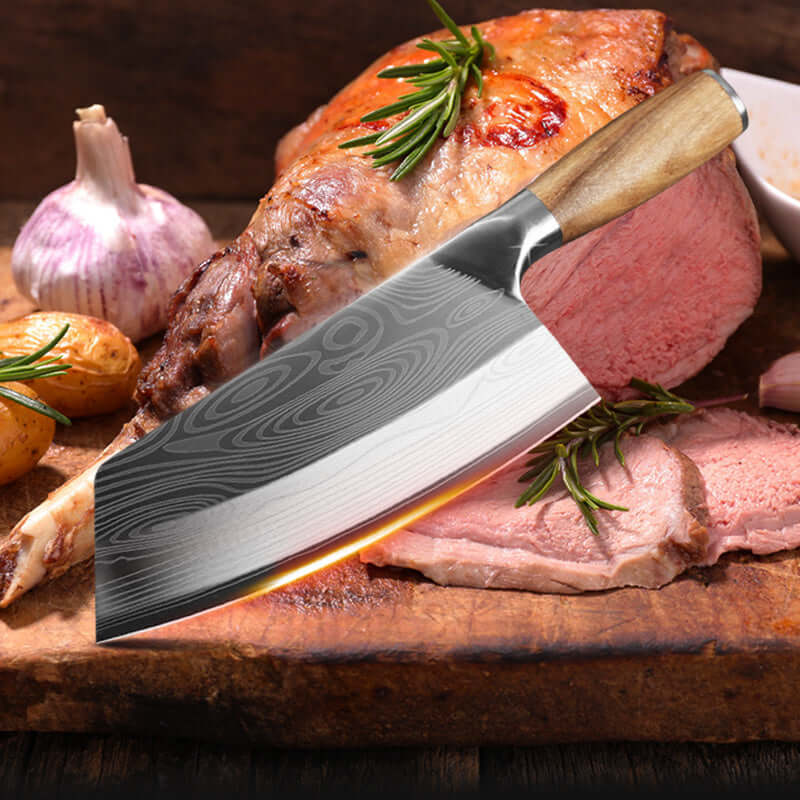 Stainless Steel Kitchen Knife on a wooden cutting board beside roasted meat and vegetables, showcasing sharpness and craftsmanship.