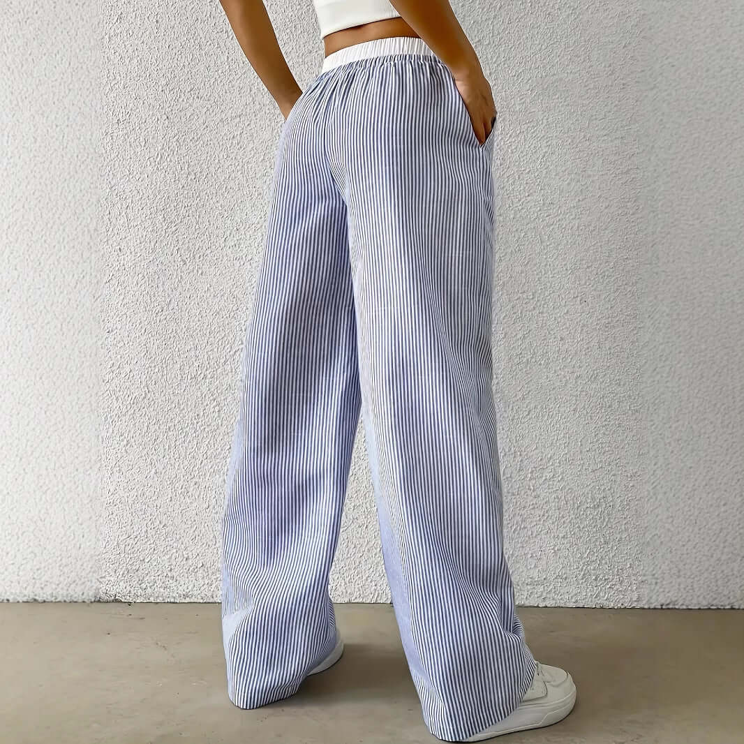 Back view of woman wearing Ladies Stripe Trousers in light blue, showcasing straight-leg design for lightweight and stylish appeal.