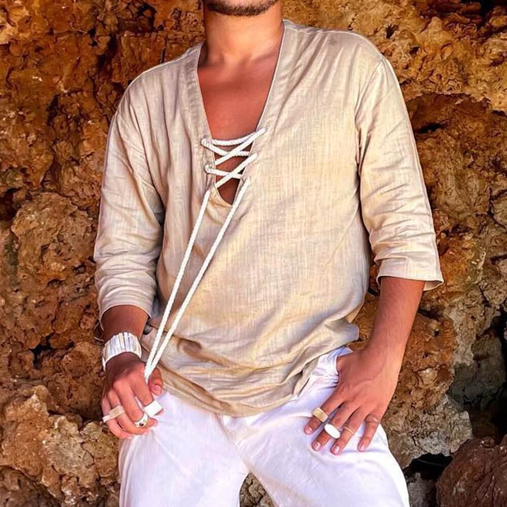 Beige Lace Up T-Shirt with white pants against a rocky background, showcasing casual and stylish fashion.