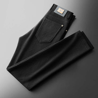 Black Jacquard Trousers showcasing elegant pattern, perfect blend of style and comfort for modern men, folded on a gray surface.