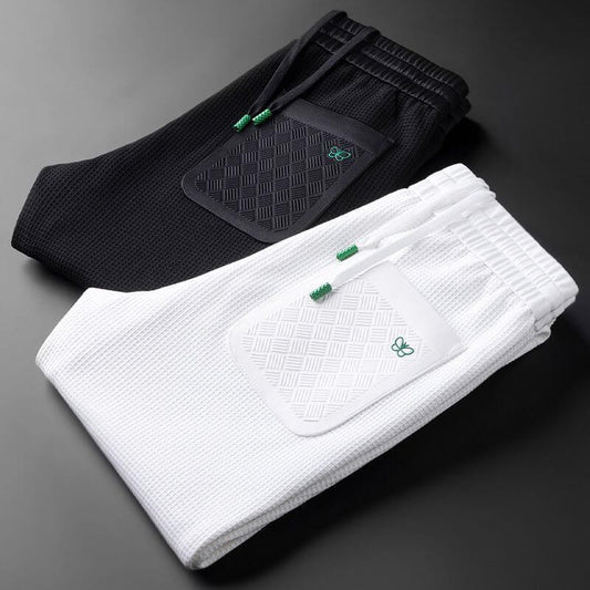 Black and white premium sports trousers for men, showcasing comfort and style for gym and casual wear.