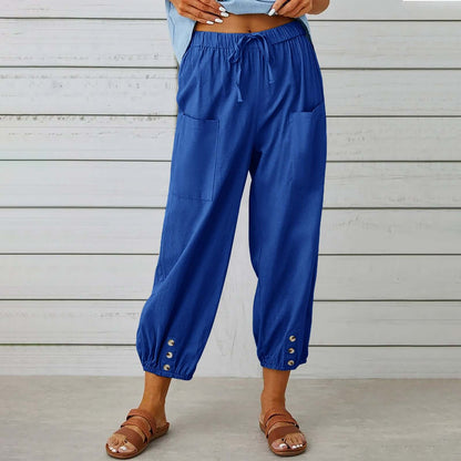 Blue ladies linen trousers with drawstring waist, featuring front pockets and ankle buttons, offering comfort and style.