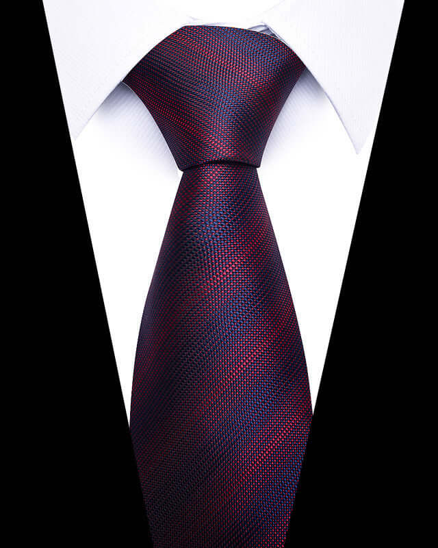 Close-up of Business Professional Tie in deep red and blue pattern, enhancing a white dress shirt's formal look.