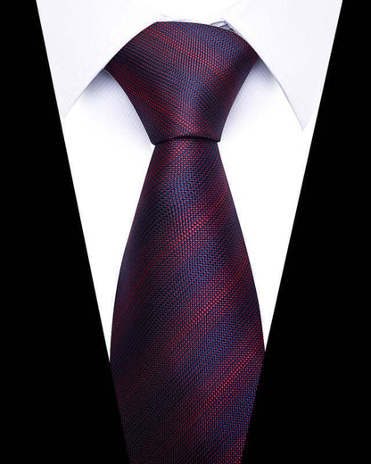 Close-up of Business Professional Tie in deep red and blue pattern, enhancing a white dress shirt's formal look.