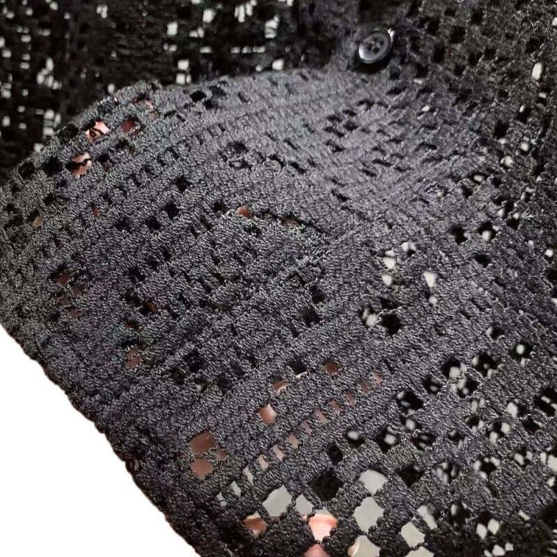 Close-up of black Italian Style Shirt showcasing intricate crochet pattern and button detail, highlighting elegance and sophistication.