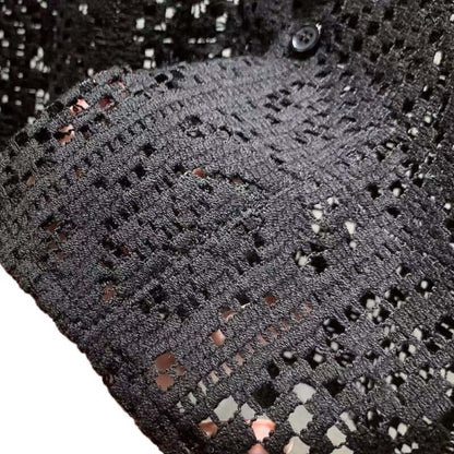 Close-up of black Italian Style Shirt showcasing intricate crochet pattern and button detail, highlighting elegance and sophistication.
