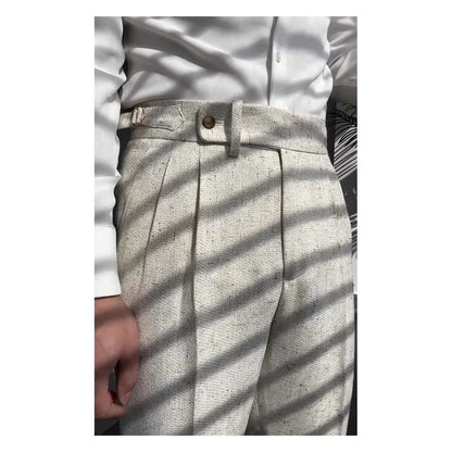 Close-up of stylish straight legged trousers in a light color, paired with a white button-up shirt, perfect for a versatile wardrobe.