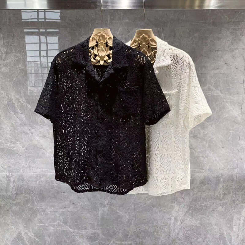 Elegant black and white Italian style shirts displayed on hanger, showcasing intricate design and craftsmanship.