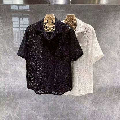 Elegant black and white Italian style shirts displayed on hanger, showcasing intricate design and craftsmanship.