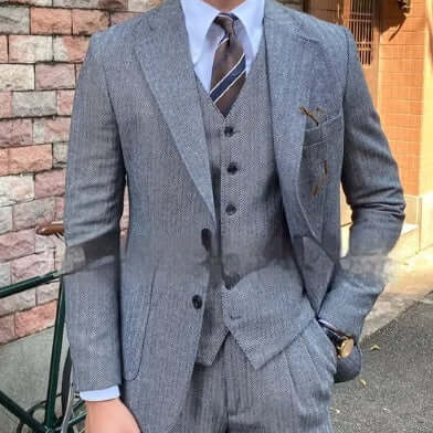 Elegant three-piece herringbone suit for men, perfect for sophisticated style and versatile occasions.