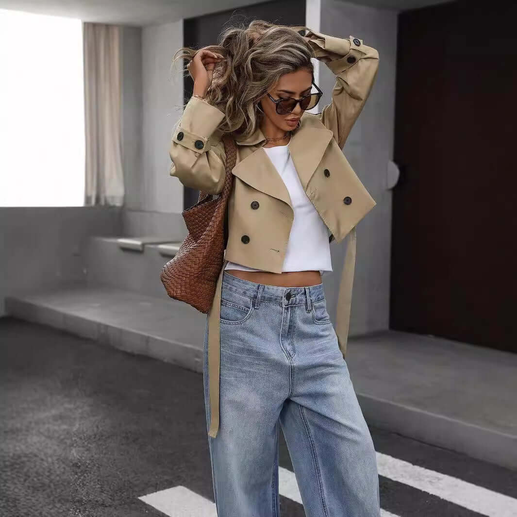 Fashionable woman in khaki ladies casual blazer pairing with sunglasses and jeans, creating a stylish and confident street look.