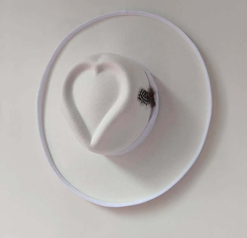 Heart Hat made of wool, featuring a heart shape on top, perfect for warmth and comfort in cold weather. Warp knitting and satin design.