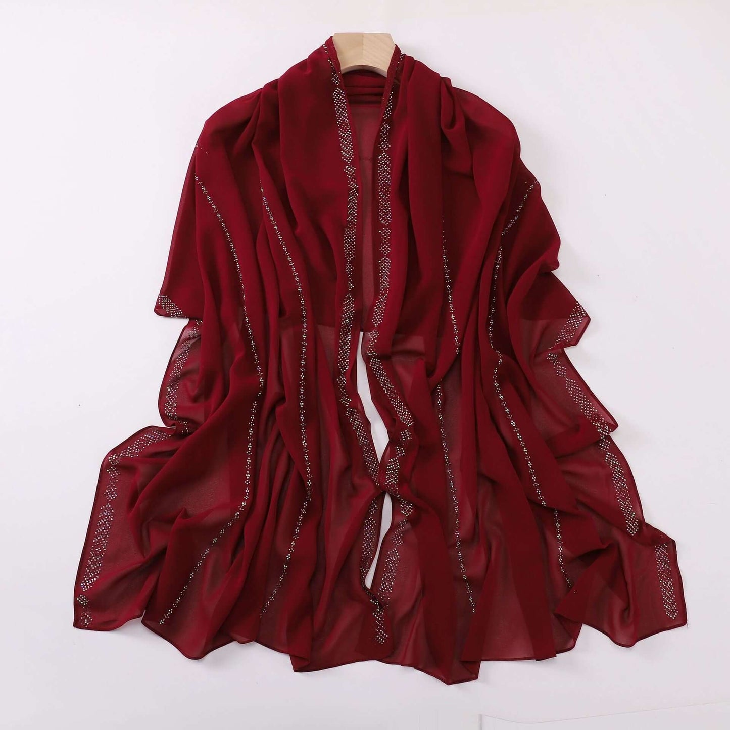Ladies chiffon scarf in deep red, featuring delicate fabric and versatile styling options. Ideal for adding elegance to any outfit.