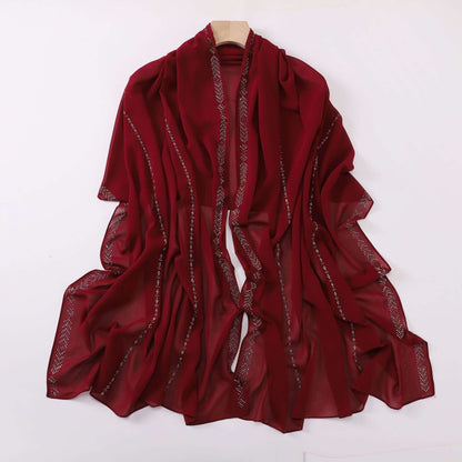 Ladies chiffon scarf in deep red, featuring delicate fabric and versatile styling options. Ideal for adding elegance to any outfit.