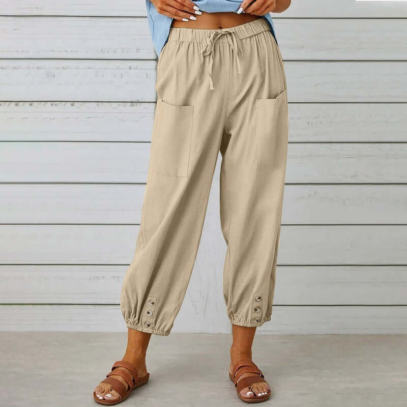 Ladies linen trousers with elastic waistband, pocket details, and button cuffs for comfortable, breathable style.