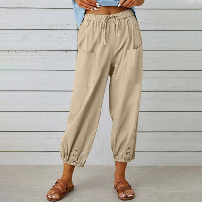 Ladies linen trousers with elastic waistband, pocket details, and button cuffs for comfortable, breathable style.