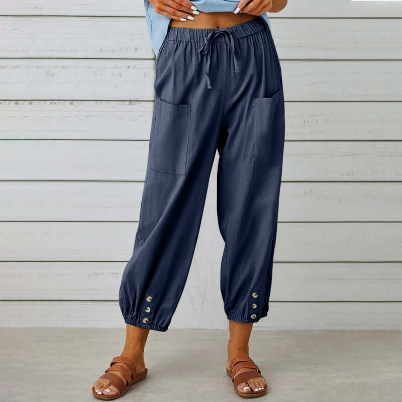 Ladies navy linen trousers with drawstring waist and button detail, crafted from a cotton-linen blend for breathable comfort.