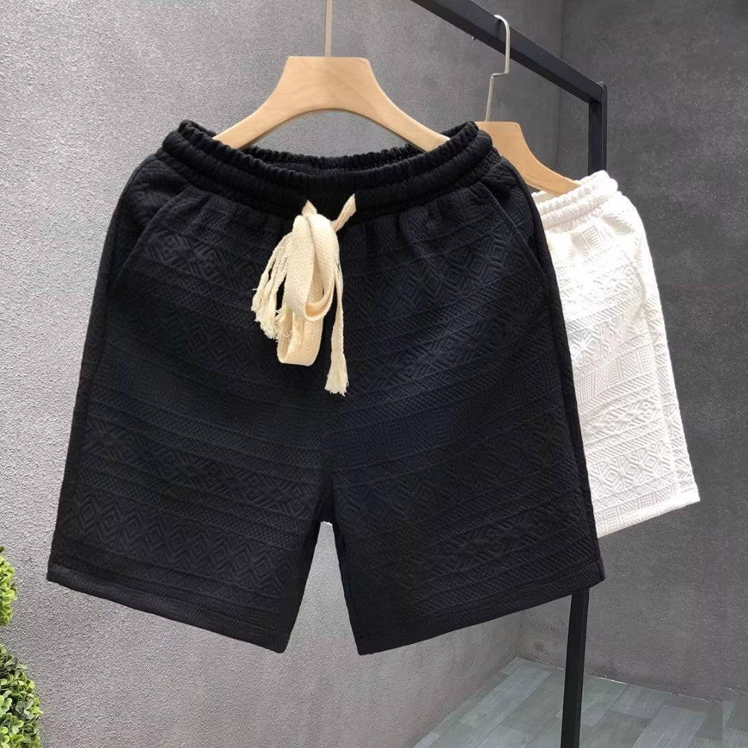 Luxurious black and white high-end men's shorts with designer detailing, hanging on wooden hangers for ultimate comfort and style.