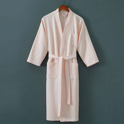 Luxurious unisex spa robe featuring cotton and mink hair fabrics, hanging on a wooden hanger against a dark background.