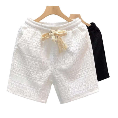 Luxurious white and black high-end men's shorts with elegant design on wooden hanger, perfect for style and comfort.