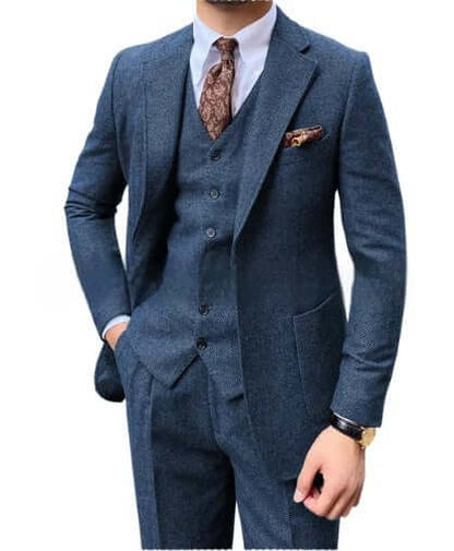 Man wearing a stylish blue 3-piece herringbone suit, showcasing sophistication and versatility for various occasions.