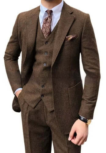Man wearing a stylish brown 3-piece herringbone suit with a patterned tie, perfect for an elegant and sophisticated look.