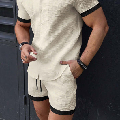 Man wearing stylish men's beach attire shorts and matching shirt in a casual outdoor setting.