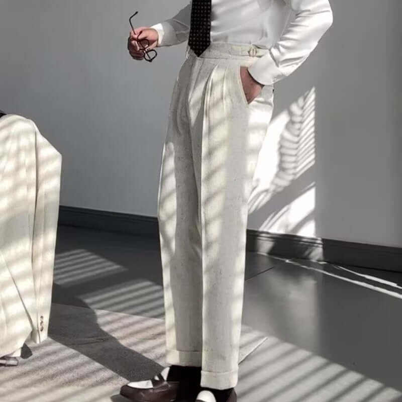 Man wearing stylish straight legged trousers, paired with a white shirt and tie, showcasing modern fashion and versatility.