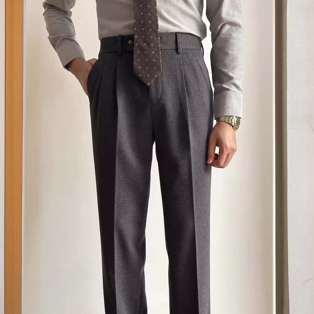 Man wearing stylish suit slacks with a tie and dress shirt, showcasing professional attire for office and formal events.