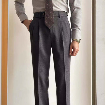 Man wearing stylish suit slacks with a tie and dress shirt, showcasing professional attire for office and formal events.