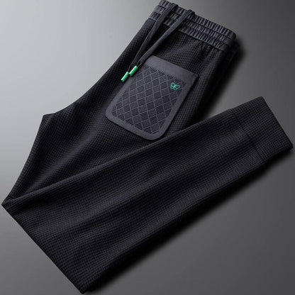 Premium men's sports trousers with pocket design, ideal for gym and casual wear, offering comfort and versatility.