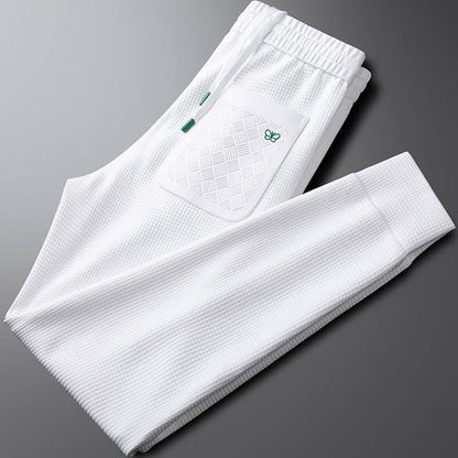 Premium white sports trousers for men, featuring a stylish pocket design, perfect for gym workouts and casual outings.