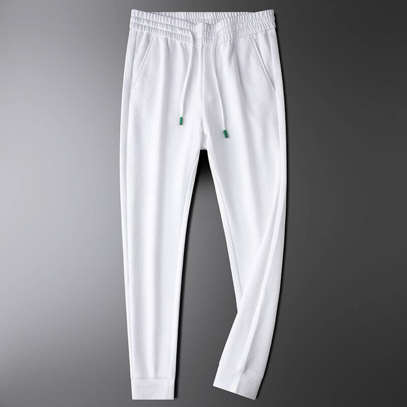 Premium white sports trousers for men, perfect for gym and casual outings, showcasing stylish and versatile activewear.