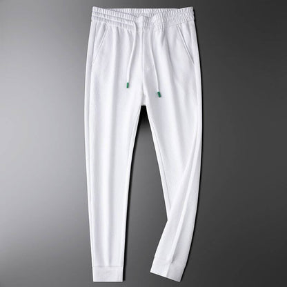 Premium white sports trousers for men, perfect for gym and casual outings, showcasing stylish and versatile activewear.