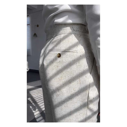 Side view of elegant white straight legged trousers with a buttoned pocket detail under sunlight, ideal for versatile styling.