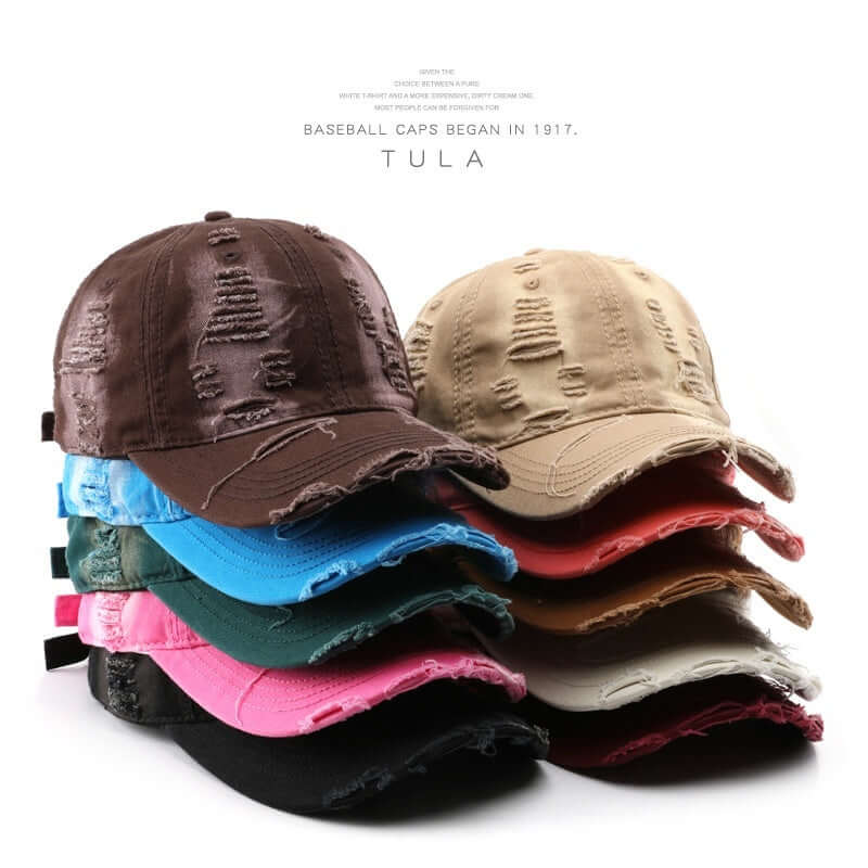 Stack of colorful Worn Out Caps showcasing distressed design, perfect for a casual and trendy style upgrade.