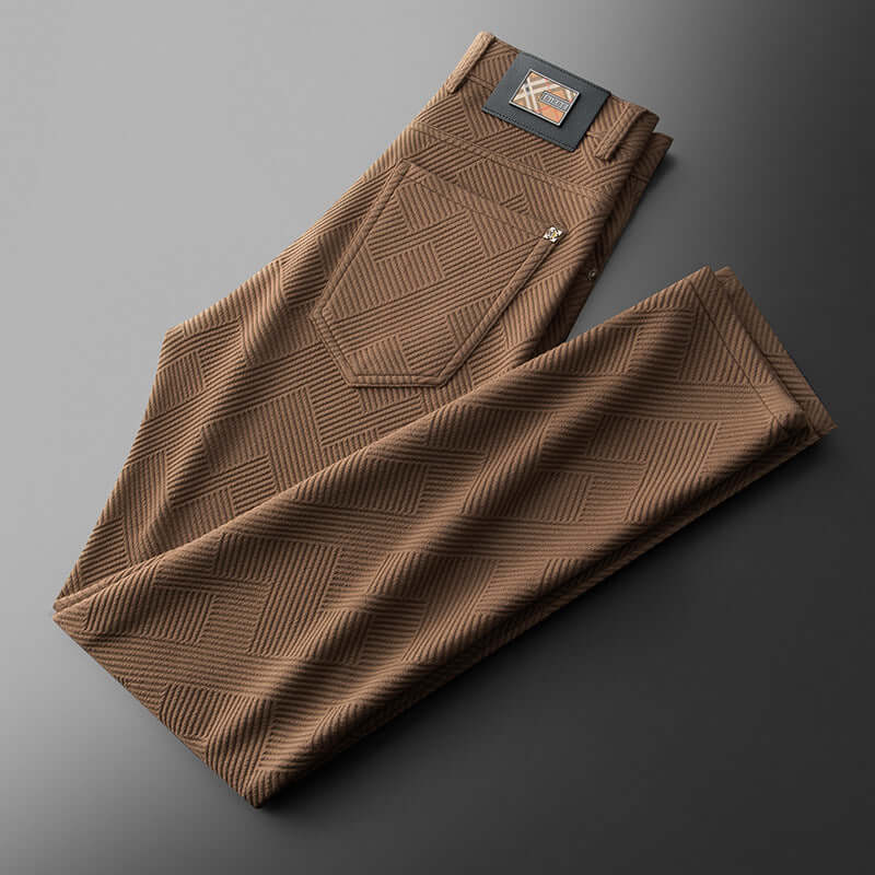 Stylish brown jacquard trousers folded neatly, showcasing modern patterns and premium fabric for trendy comfort and versatility.