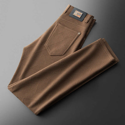 Stylish brown jacquard trousers folded neatly, showcasing modern patterns and premium fabric for trendy comfort and versatility.